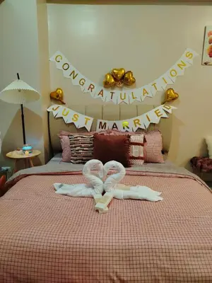 a bedroom with a bed with two swans on it at Cozy Condo at Eighty One Newport Blvd across NAIA Terminal 3 in Manila