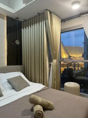a bedroom with a bed and a large window at Stylish 1BR Near Airport Facing the Bay - 7b in Manila