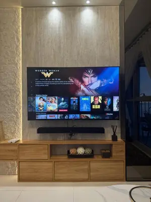 a flat screen tv sitting on top of a entertainment center at Stylish 1BR Near Airport Facing the Bay - 7b in Manila