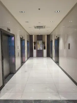 an empty hallway of a building with glass doors at Staycations Up Above 17 at BGC in Manila