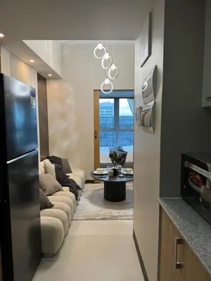 a living room with a couch and a table at Staycations Up Above 17 at BGC in Manila