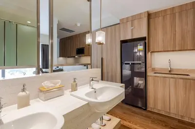 a bathroom with two sinks and a large mirror at Novotel Suites Manila Aqua Residences Near Makati by Hamodi'sCrib in Manila