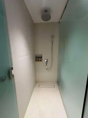 a bathroom with a shower stall with a shower at Novotel Suites Manila Aqua Residences Near Makati by Hamodi'sCrib in Manila