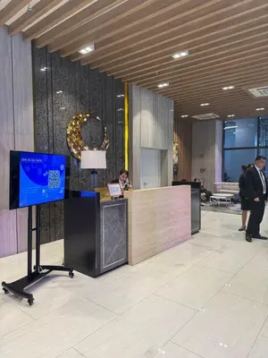 a lobby with a reception desk and a tv at Staycations Up Above 13 at BGC in Manila