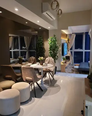 a living room with tables and chairs and a couch at Staycations Up Above 13 at BGC in Manila
