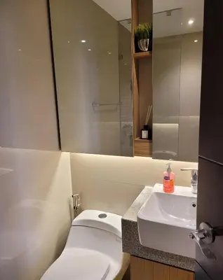 a bathroom with a white toilet and a sink at Uptown Parksuites Tower 2 BGC - Staycations Up Above 9 in Manila
