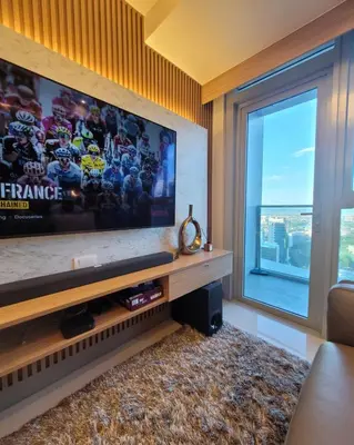 a living room with a flat screen tv and a window at Uptown Parksuites Tower 2 BGC - Staycations Up Above 9 in Manila