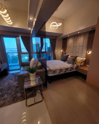a large bedroom with a bed and a couch at Uptown Parksuites Tower 2 BGC - Staycations Up Above 9 in Manila