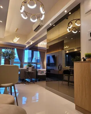 a living room with a large glass wall at Uptown Parksuites Tower 2 BGC - Staycations Up Above 9 in Manila