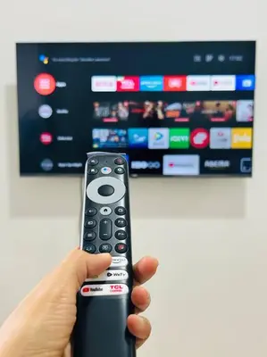 a person holding a remote control in front of a tv at Budget Family Room at Ace Suites by the Famous Indoor Water Spa in Manila