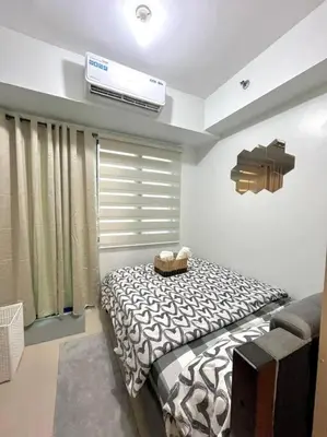 a bedroom with a zebra print bed in a room at Sea Residences by Richnells in Manila