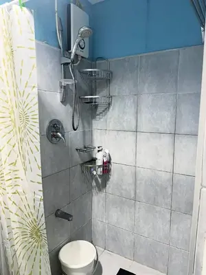 a bathroom with a shower with a toilet in it at Sea Residences by Richnells in Manila