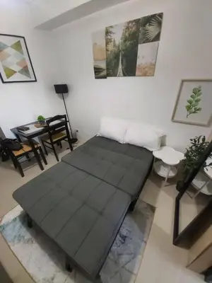 a living room with a couch and a table at Sea Residences by Richnells in Manila