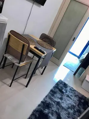 a room with a desk and a chair and a keyboard at Sea Residences by Richnells in Manila