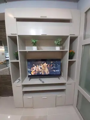 a white entertainment center with a flat screen tv at Sea Residences by Richnells in Manila