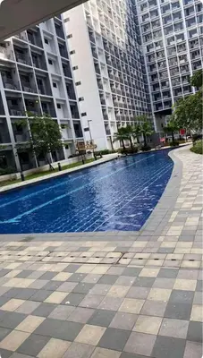 a swimming pool in front of some tall buildings at Nordic Style - 2BR Shore 2 Residences Tower 2 in Manila