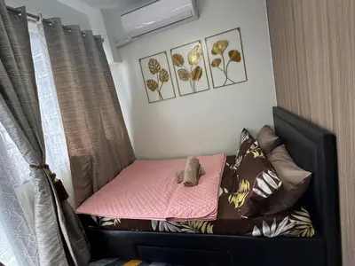 a small bed with a teddy bear on it in a bedroom at Nordic Style - 2BR Shore 2 Residences Tower 2 in Manila