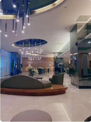 a lobby with a couch and a chandelier at Nordic Style - 2BR Shore 2 Residences Tower 2 in Manila