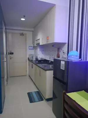 a kitchen with a sink and a counter top at Reynas place at sea residences in Manila