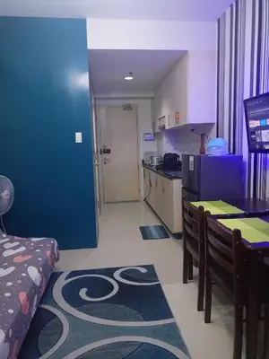 a room with a kitchen and a dining room at Reynas place at sea residences in Manila