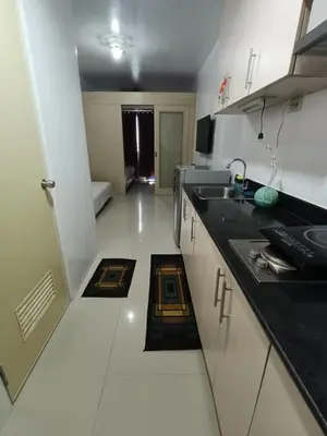 a kitchen with a sink and a counter top at Mall of Asia Sea Residences Staycation Pasay City in Manila