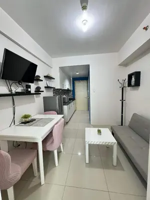 a living room with a table and a couch at Mall of Asia Sea Residences Staycation Pasay City in Manila