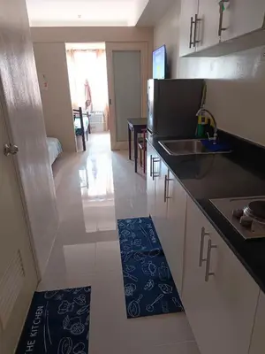 a kitchen with a sink and a counter top at Mall of Asia Sea Residences Staycation Pasay City in Manila