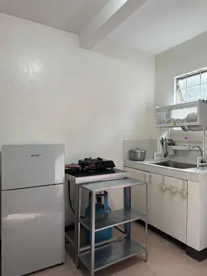 a small kitchen with a sink and a stove at 2 StoryHome in Tanza near SM along Main Road in Tanza