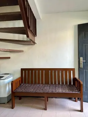 a wooden bench sitting in the corner of a room at 2 StoryHome in Tanza near SM along Main Road in Tanza