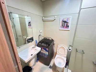 a small bathroom with a toilet and a sink at Kota S Residences in Manila