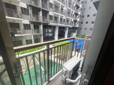 a balcony with a view of a apartment building at Kota S Residences in Manila