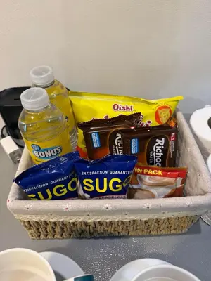 a basket filled with food and drinks on a counter at Kota S Residences in Manila