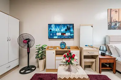 a living room with a desk and a tv at Precious Florannjoe in Manila