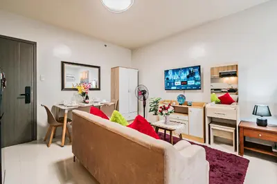 a living room with a couch and a kitchen at Precious Florannjoe in Manila