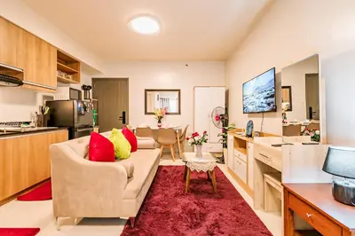a living room with a couch and a kitchen at Precious Florannjoe in Manila