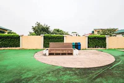 a bench sitting on top of a green yard at Precious Florannjoe in Manila