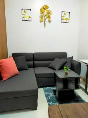a living room with a couch and a table at Jireh's Staycation in Makati in Manila
