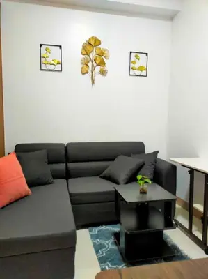 a living room with a couch and a table at Jireh's Staycation in Makati in Manila