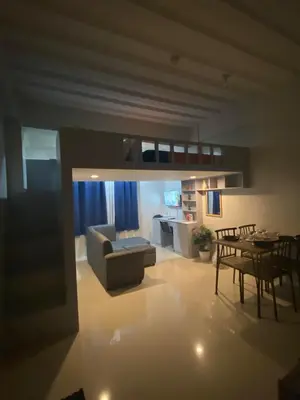a living room with a couch and a table at Affordable Condo near in NAIA in Manila