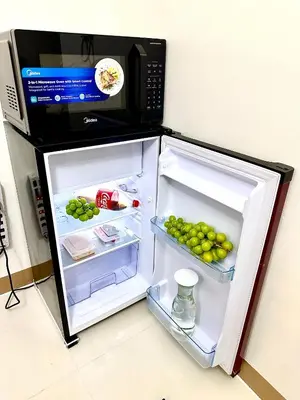 a refrigerator with its door open and a microwave at High Rise Condo with Balcony, Pool, Grand Lobby, and Sky Garden 22F in Manila