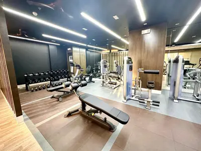 a gym with several treadmills and machines at High Rise Condo with Balcony, Pool, Grand Lobby, and Sky Garden 22F in Manila