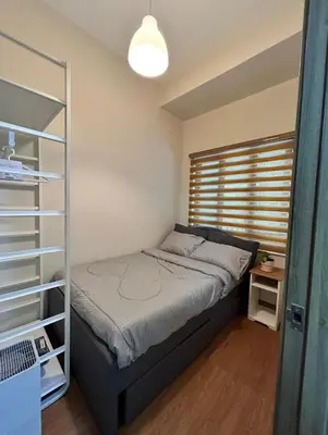 a small bedroom with a bed and a window at Casa Bella at S Residence, Near SM Mall of Asia in Manila