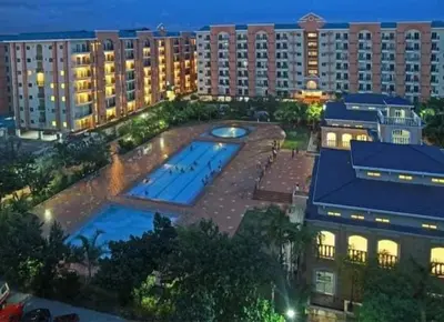 an aerial view of a large building with a swimming pool at Casa Luz Budget Condotel in Manila