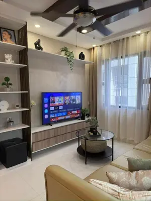 a living room with a large flat screen tv at Mi Casa en Manila in Manila