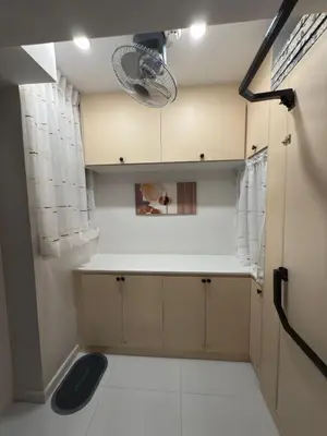 a small kitchen with a white counter top at Mi Casa en Manila in Manila