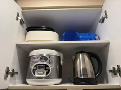 a kitchen drawer with a toaster and other kitchen items at Mi Casa en Manila in Manila