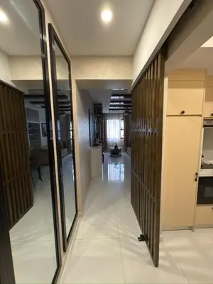 a hallway in a building with glass doors and a room at Mi Casa en Manila in Manila