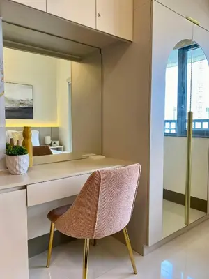 a chair sitting in front of a desk with a mirror at Casa Eleganza at Fame Residences - 1BR corner unit, CBD, Gym, Pool, WiFi, Great View in Manila