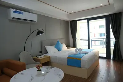 a hotel room with a bed and a table at Golden Seagulls Hotel in Manila