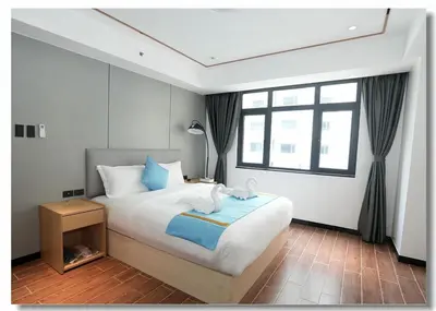 a bedroom with a large bed and a window at Golden Seagulls Hotel in Manila